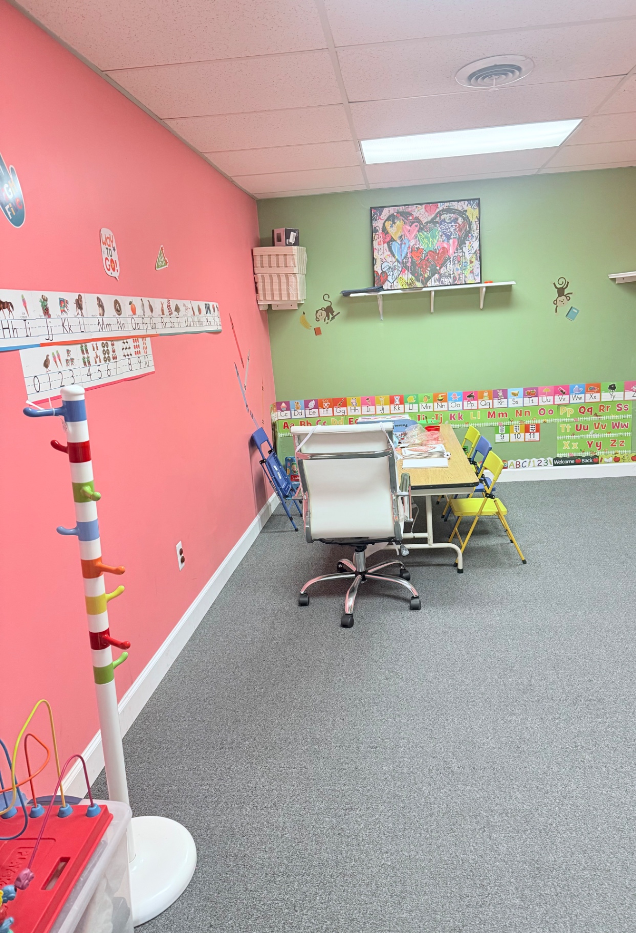 A small-group classroom with alphabet charts and child-sized seating