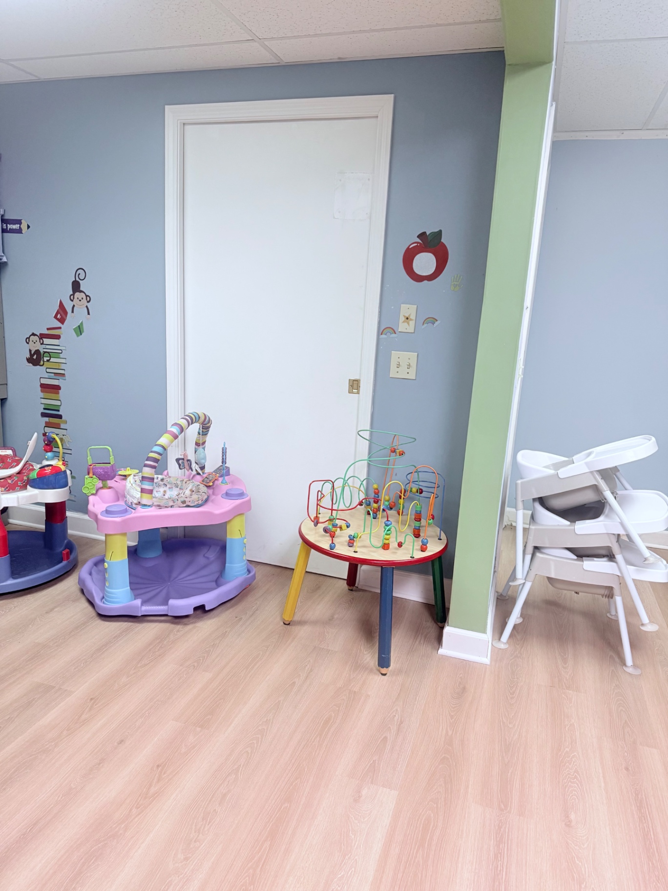 Infant and toddler area with activity tables and high chairs