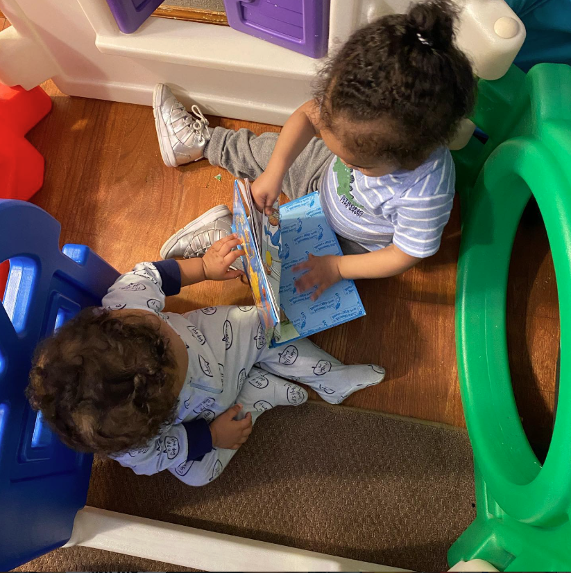 Two Eastwood toddlers sharing a picture book together in the play area